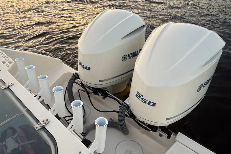 Slide: The Image of 2014 Pursuit S 280 Sport boat with dual Yamaha 250 outboard engines on water. - 26