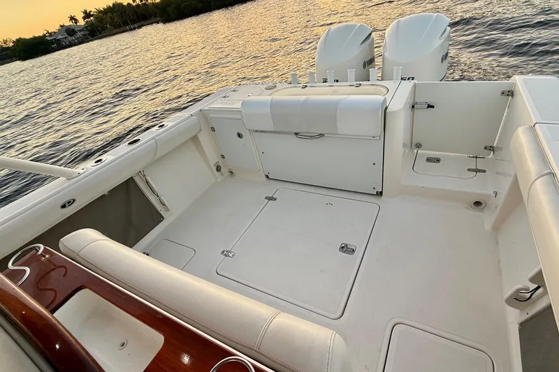 Slide: The Image of 2014 Pursuit S 280 Sport boat interior with dual engines, on calm water at sunset. - 29