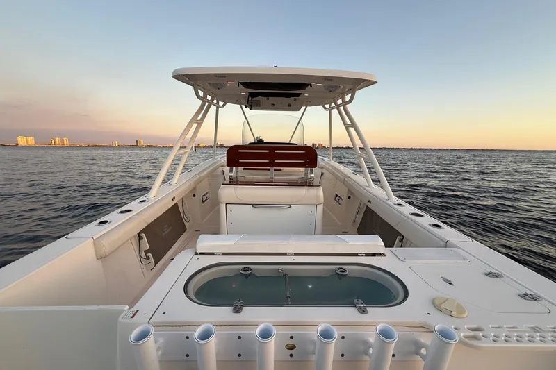 Slide: The Image of 2014 Pursuit S 280 Sport boat on calm water at sunset. - 30