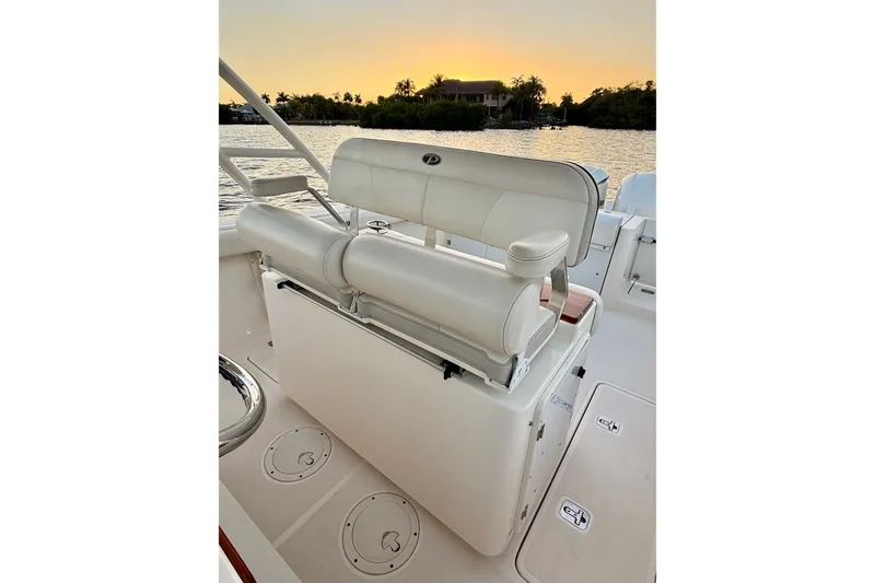 Slide: The Image of 2014 Pursuit S 280 Sport boat interior with seating, sunset view over water. - 41