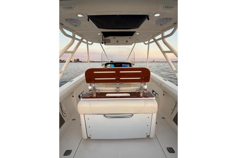 Slide: The Image of 2014 Pursuit S 280 Sport boat interior with seating, ocean view, and city skyline. - 47