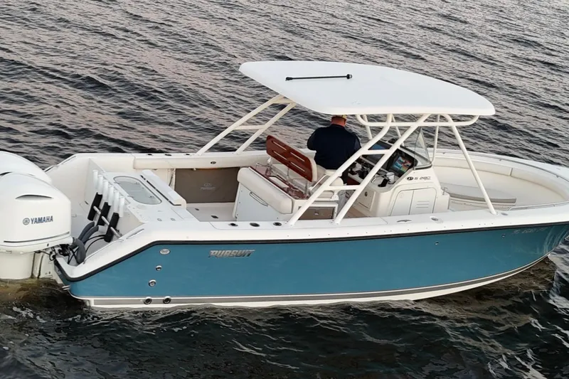 Slide: The Image of 2014 Pursuit S 280 Sport boat on water, featuring Yamaha engine. - 6