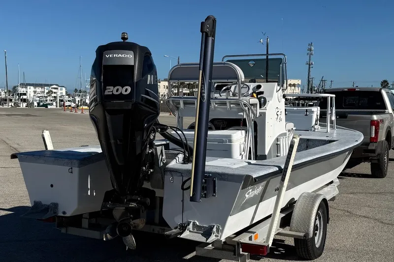 Slide: The Image of 2006 Shoalwater 21 Cat boat with Verado 200 engine on trailer at marina. - 4
