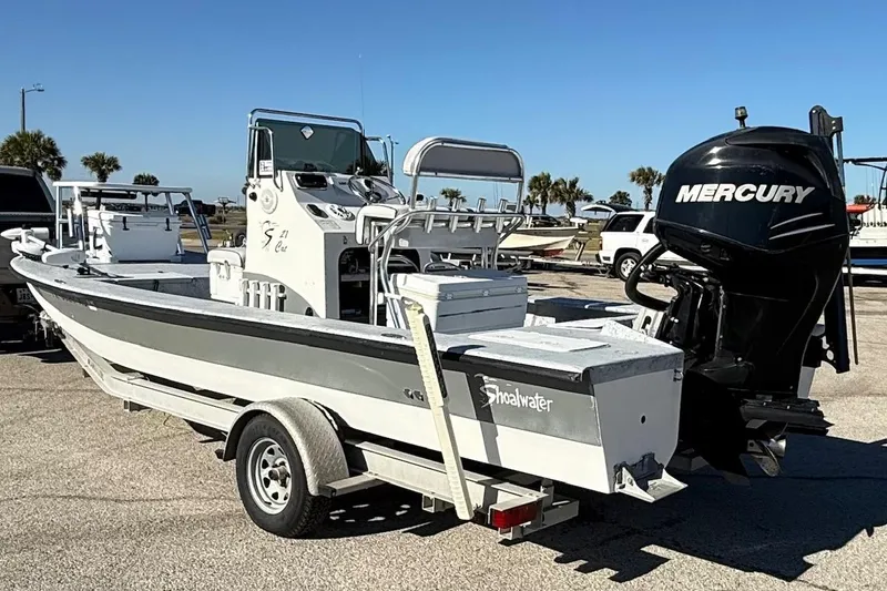 Slide: The Image of 2006 Shoalwater 21 Cat boat with Mercury engine on trailer. - 5