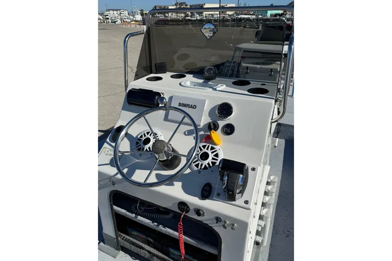 Slide: The Image of 2006 Shoalwater 21 Cat boat console with steering wheel and controls. - 7