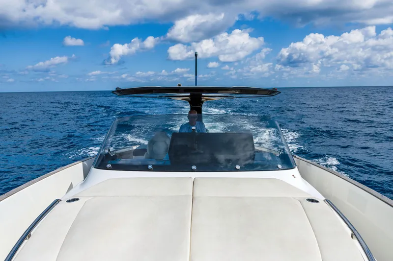 Slide: The Image of 2024 Solaris Power 44 yacht cruising on open sea under blue sky. - 12