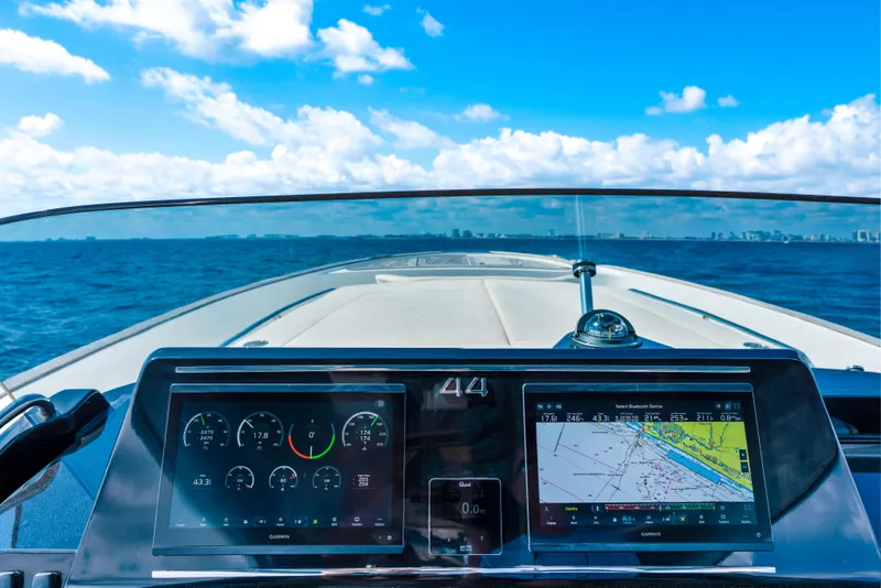 Slide: The Image of 2024 Solaris Power 44 yacht dashboard with navigation screens, cruising on open sea. - 18