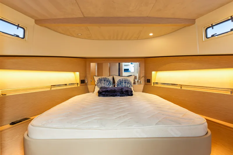 Slide: The Image of Luxurious 2024 Solaris Power 44 yacht cabin with elegant bedding and ambient lighting. - 25