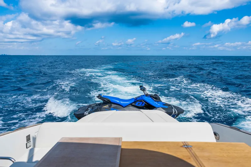 Slide: The Image of 2024 Solaris Power 44 yacht with jet ski on open sea, under blue sky. - 7