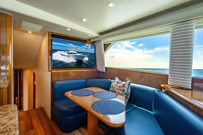 Slide: The Image of Luxurious interior of 2006 Viking 56 Convertible yacht with ocean view and cozy seating. - 17