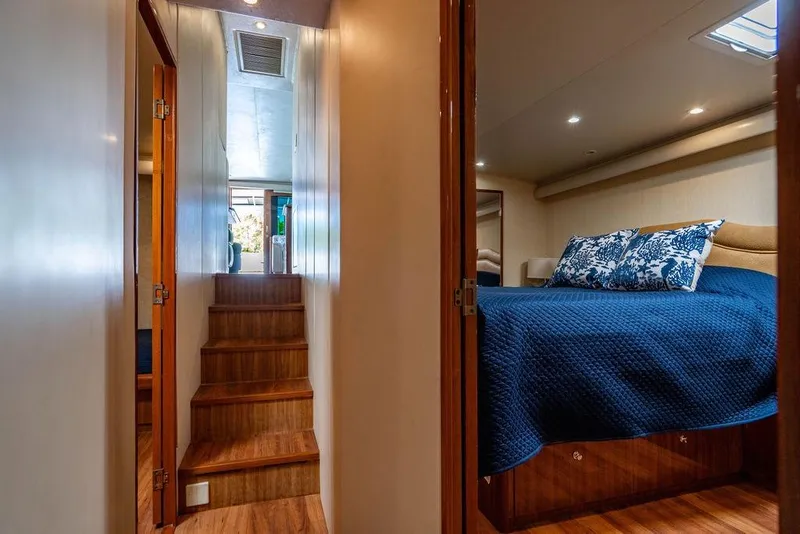 Slide: The Image of Interior of 2006 Viking 56 Convertible yacht with cozy bedroom and wooden stairs. - 23