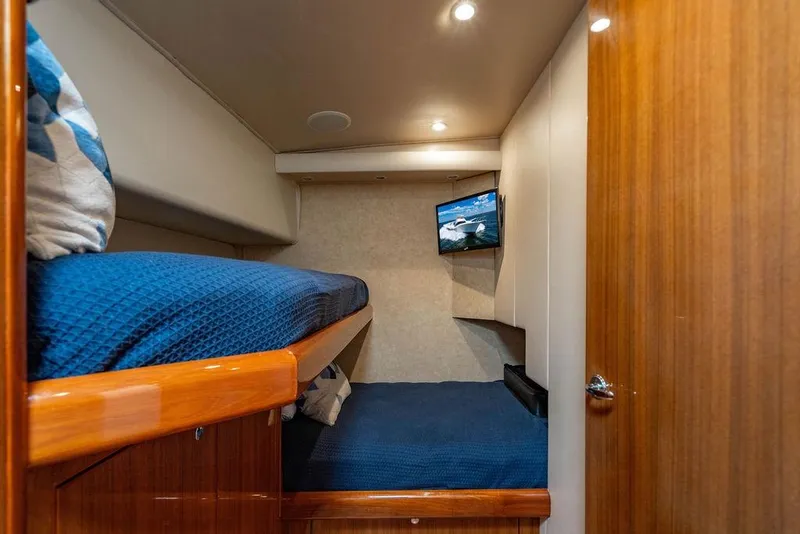 Slide: The Image of Interior of 2006 Viking 56 Convertible yacht with cozy bunk beds and TV. - 27