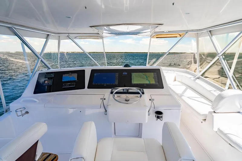 Slide: The Image of 2006 Viking 56 Convertible yacht helm with navigation screens and ocean view. - 33
