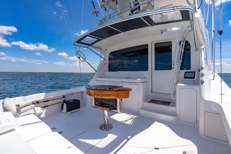 Slide: The Image of 2006 Viking 56 Convertible yacht deck with ocean view and fishing equipment. - 43