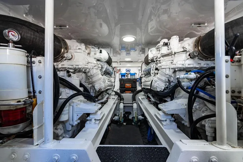 Slide: The Image of Engine room of a 2006 Viking 56 Convertible yacht, showcasing dual engines and mechanical components. - 51