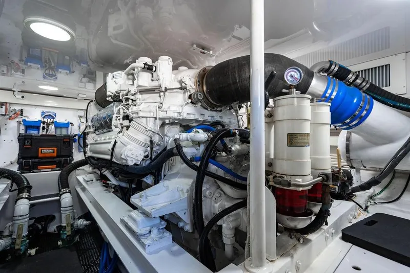 Slide: The Image of Engine room of a 2006 Viking 56 Convertible yacht, showcasing detailed machinery and components. - 53