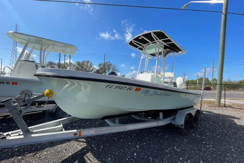 The Image of 1973 Mako 1901 Inshore boat on trailer under clear blue sky. - 1