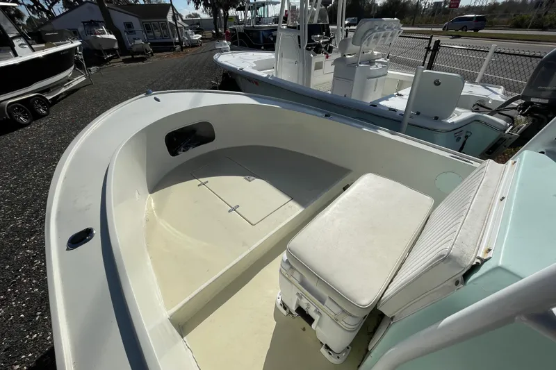 Slide: The Image of 1973 Mako 1901 Inshore boat interior with seating and storage, parked outdoors. - 7