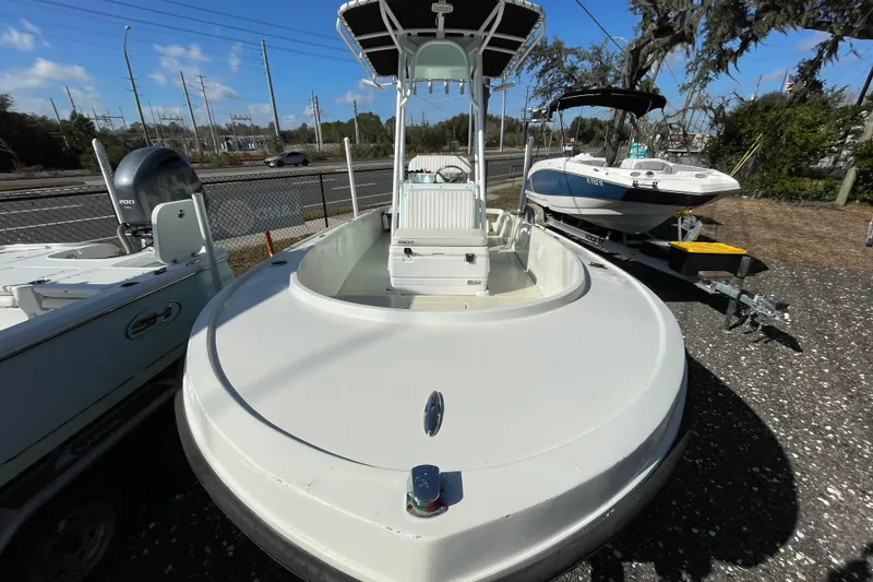 Slide: The Image of 1973 Mako 1901 Inshore boat with T-top, parked on gravel lot. - 8