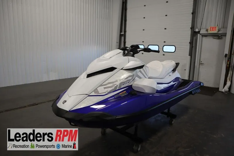 The Image of 2024 Yamaha WaveRunner GP SVHO in showroom, featuring sleek white and blue design. - 1