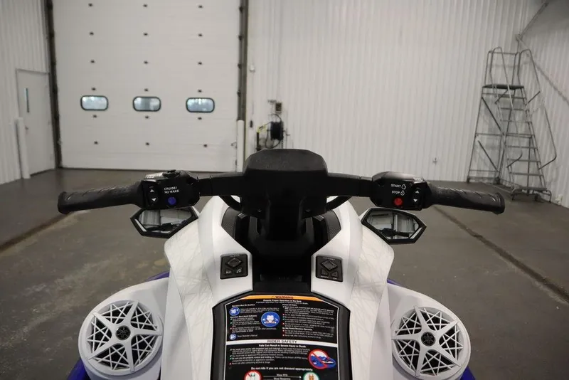 Slide: The Image of 2024 Yamaha WaveRunner GP SVHO handlebars in a garage setting. - 11