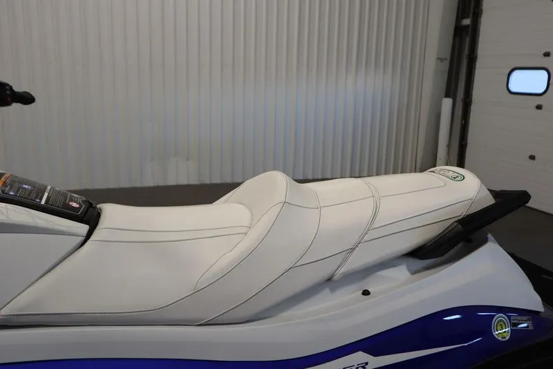 Slide: The Image of 2024 Yamaha WaveRunner GP SVHO with sleek white seat design in a garage setting. - 18