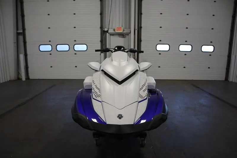 Slide: The Image of 2024 Yamaha WaveRunner GP SVHO in a garage, front view, white and blue design. - 2