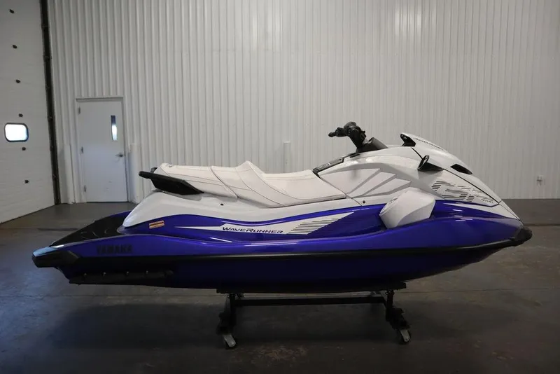 Slide: The Image of 2024 Yamaha WaveRunner GP SVHO in a showroom, side view, blue and white design. - 4