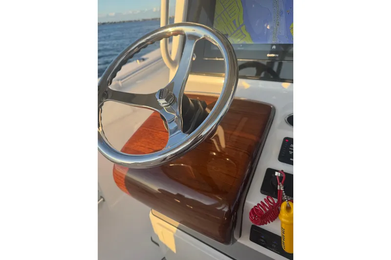 Slide: The Image of Steering wheel of 2021 Sportsman Open 352 Center Console boat with navigation display. - 13