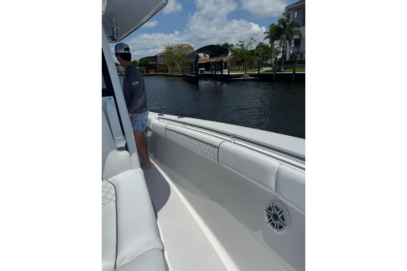 Slide: The Image of 2021 Sportsman Open 352 Center Console boat on a sunny day by the water. - 15