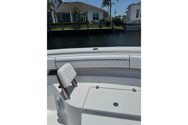 Slide: The Image of 2021 Sportsman Open 352 Center Console boat interior with quilted seating and storage. - 17