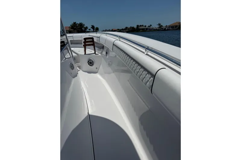 Slide: The Image of 2021 Sportsman Open 352 Center Console boat, sleek white deck, coastal background. - 19