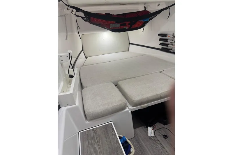 Slide: The Image of 2021 Sportsman Open 352 Center Console cabin interior with cushioned seating and storage. - 2