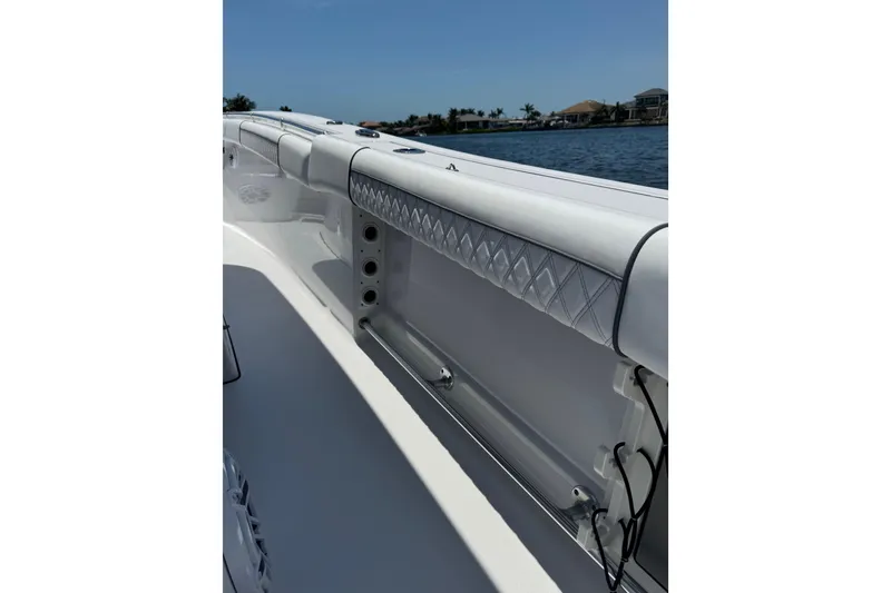 Slide: The Image of 2021 Sportsman Open 352 Center Console boat interior with quilted upholstery, on calm water. - 20