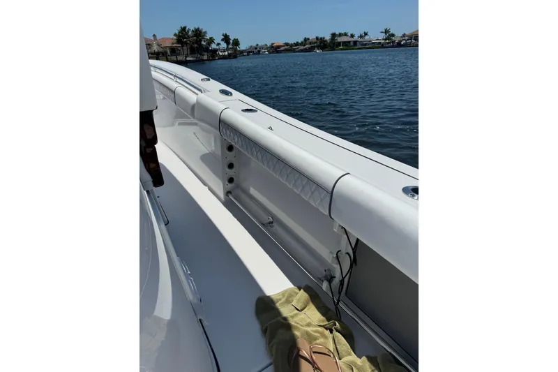 Slide: The Image of 2021 Sportsman Open 352 Center Console boat on water, sunny day, coastal view. - 21