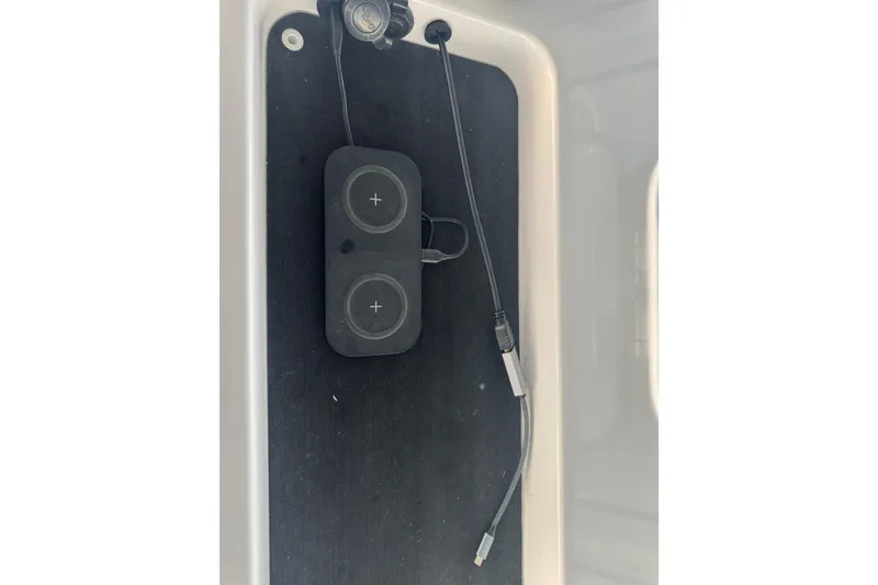 Slide: The Image of 2021 Sportsman Open 352 Center Console wireless charging pad and USB cable. - 48