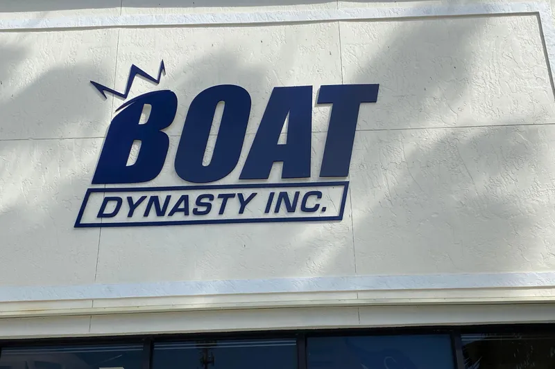 Slide: The Image of Boat Dynasty Inc. sign on textured wall, featuring Sportsman Open 352 Center Console, 2021 model. - 58