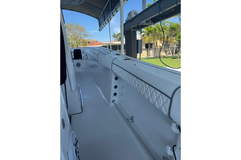 Slide: The Image of 2021 Sportsman Open 352 Center Console boat interior with white seating and canopy. - 7