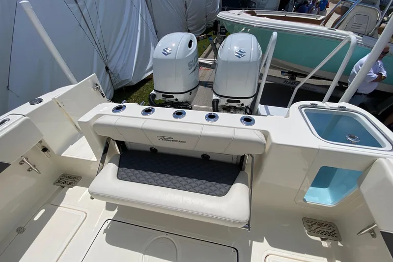 Slide: The Image of 2026 Pioneer 250 Pelagic boat with dual Suzuki outboard motors and seating area. - 12