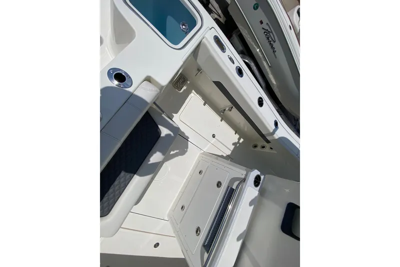 Slide: The Image of 2026 Pioneer 250 Pelagic boat interior with storage compartments and seating. - 13
