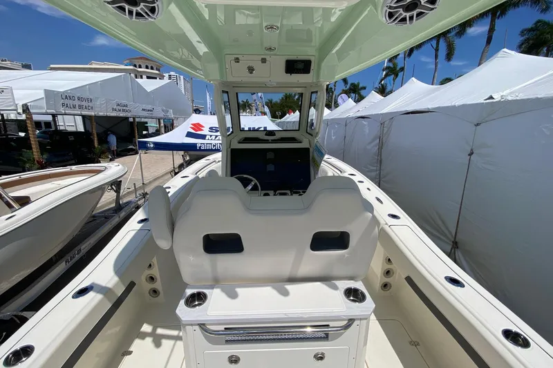 Slide: The Image of 2026 Pioneer 250 Pelagic boat interior at outdoor exhibition with tents and palm trees. - 14