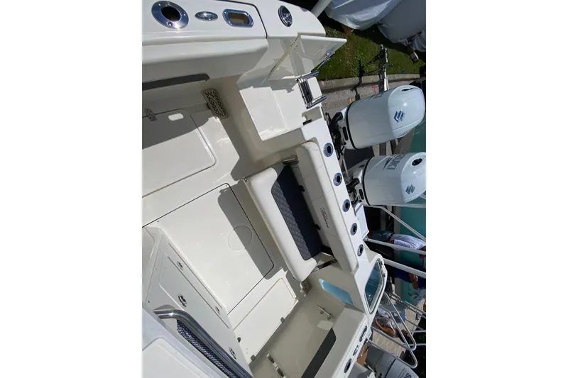 Slide: The Image of 2026 Pioneer 250 Pelagic boat interior with dual engines and seating area. - 15