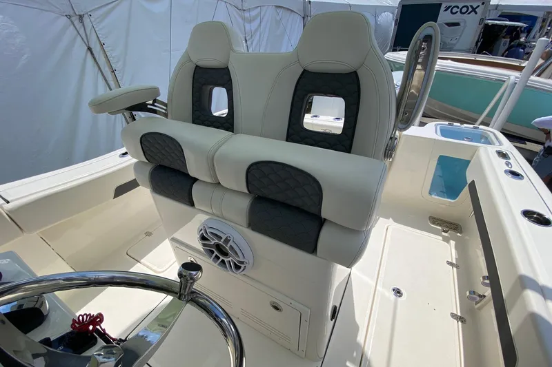Slide: The Image of Interior view of 2026 Pioneer 250 Pelagic boat with cushioned seating and storage compartments. - 18
