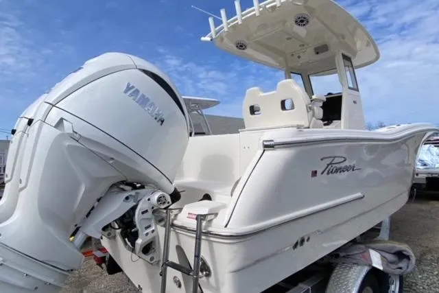 Slide: The Image of 2026 Pioneer 250 Pelagic boat interior with cushioned seating and modern design. - 21