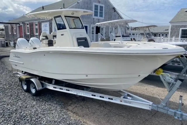 Slide: The Image of 2026 Pioneer 250 Pelagic boat with Yamaha engine, docked under clear blue sky. - 23