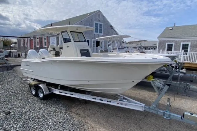 Slide: The Image of 2026 Pioneer 250 Pelagic boat with Yamaha engine on trailer, under a cloudy sky. - 24