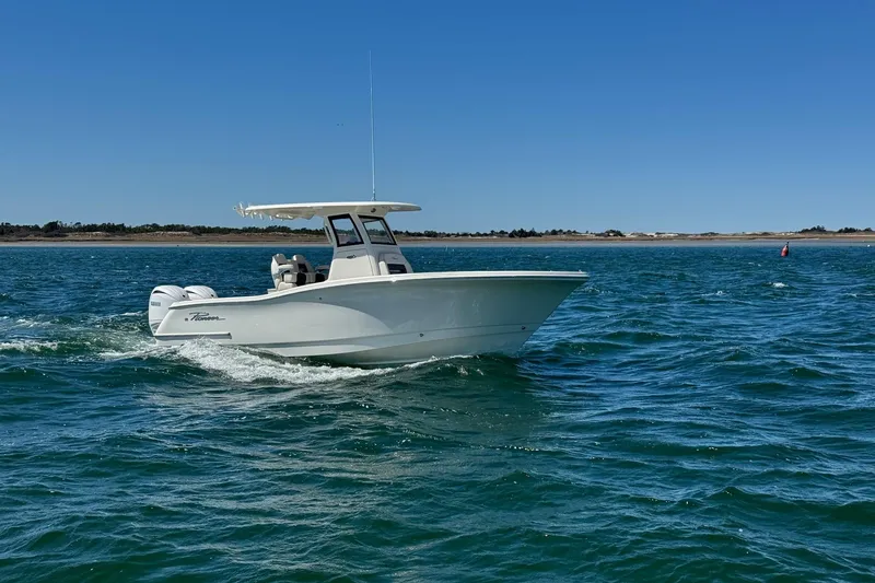 Slide: The Image of 2026 Pioneer 250 Pelagic boat cruising on open water under clear blue sky. - 29