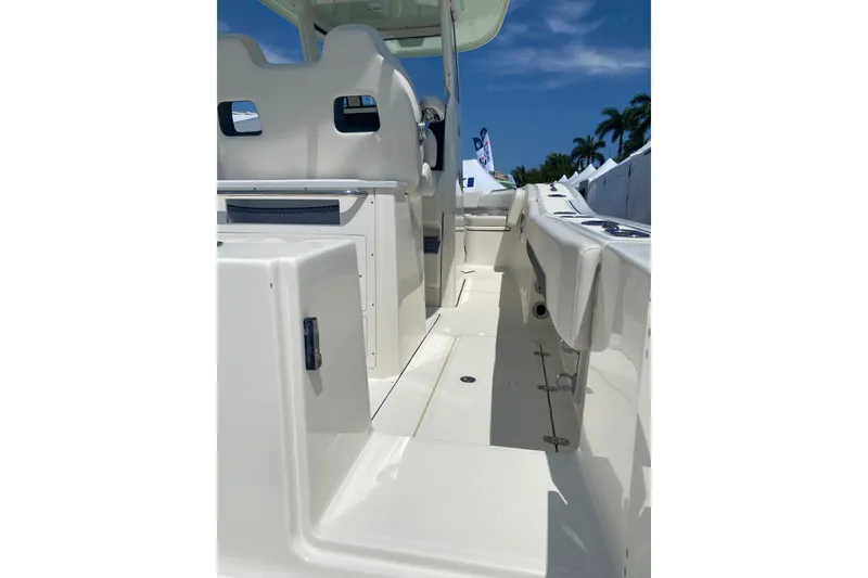 Slide: The Image of 2026 Pioneer 250 Pelagic boat interior with seating and console, under a clear blue sky. - 5