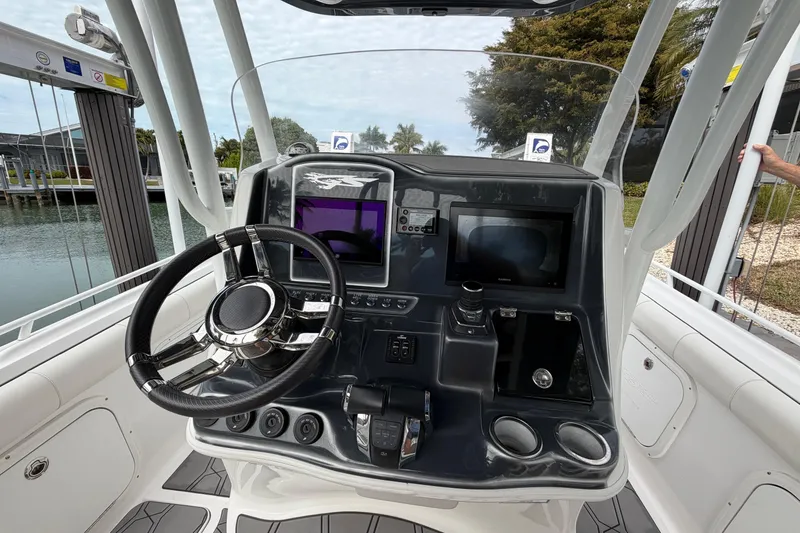 Slide: The Image of 2020 Glasstream 360 SCX boat dashboard with steering wheel and navigation screens. - 12