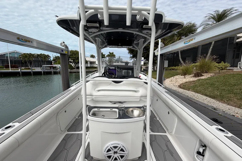 Slide: The Image of 2020 Glasstream 360 SCX boat interior with sleek design, docked by waterfront homes. - 16